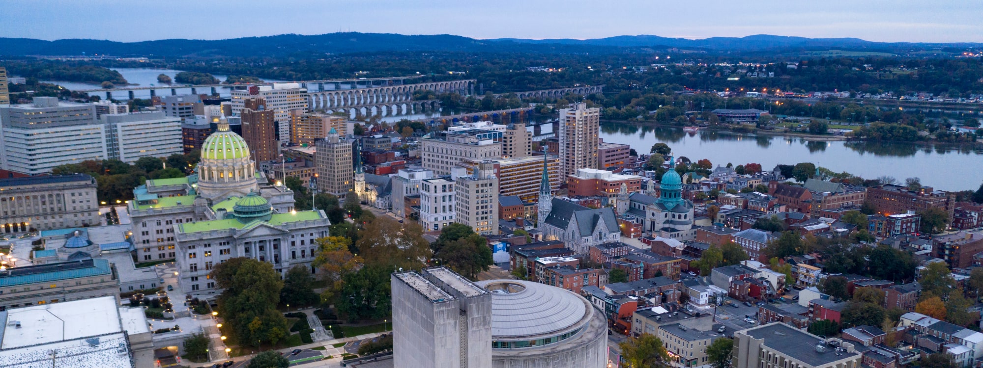 We Buy Houses Fast Harrisburg, PA banner of downtown Harrisburg with homes for PA Home Solutions